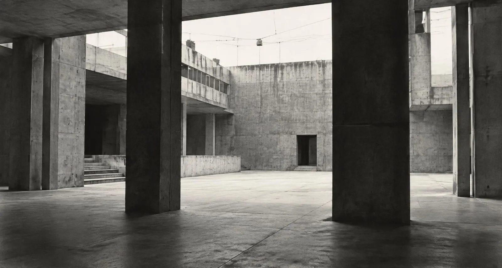 Synthetic monochrome artwork of a concrete civic undercroft with pillars.